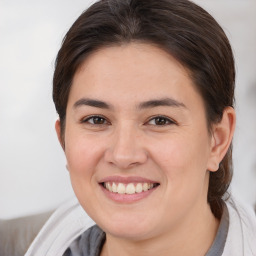 Joyful white young-adult female with medium  brown hair and brown eyes