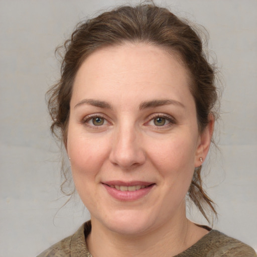 Joyful white adult female with medium  brown hair and grey eyes