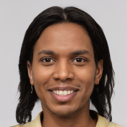 Joyful latino young-adult male with medium  brown hair and brown eyes