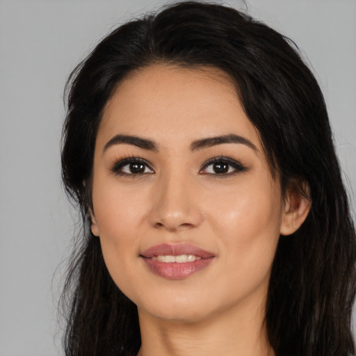 Joyful latino young-adult female with long  black hair and brown eyes