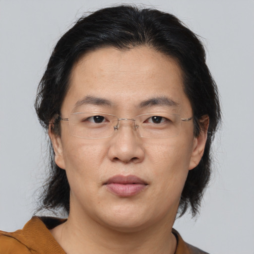 Joyful asian adult female with medium  brown hair and brown eyes
