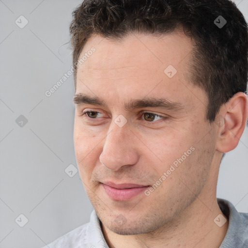 Joyful white adult male with short  brown hair and brown eyes