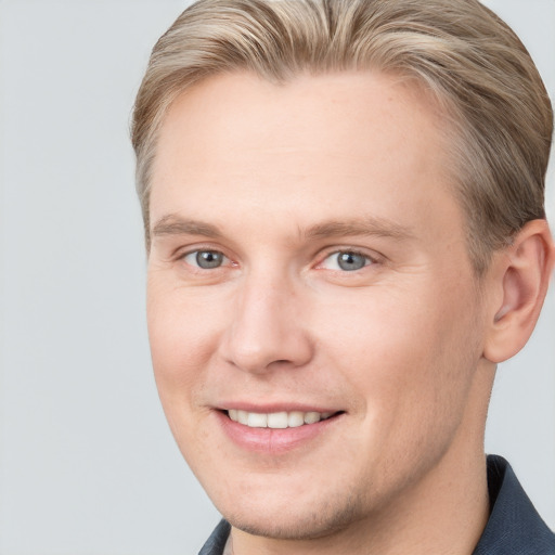 Joyful white adult male with short  brown hair and grey eyes