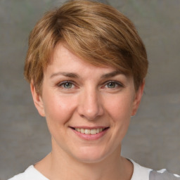 Joyful white adult female with short  brown hair and grey eyes