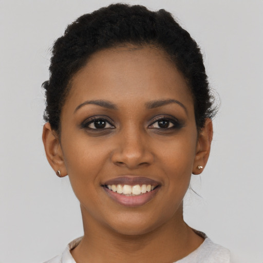 Joyful black young-adult female with short  brown hair and brown eyes
