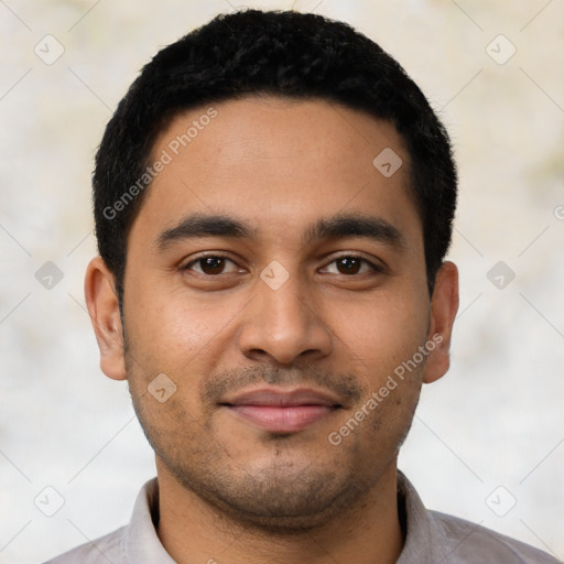 Joyful latino young-adult male with short  black hair and brown eyes