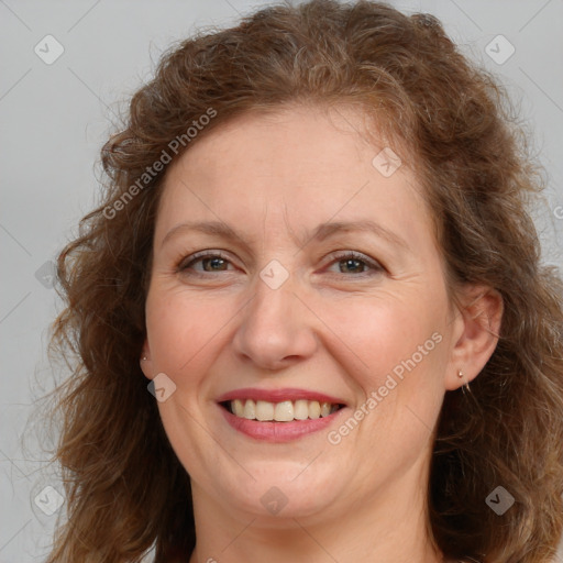 Joyful white adult female with long  brown hair and brown eyes