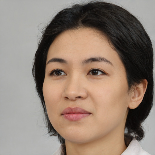 Joyful asian young-adult female with medium  black hair and brown eyes