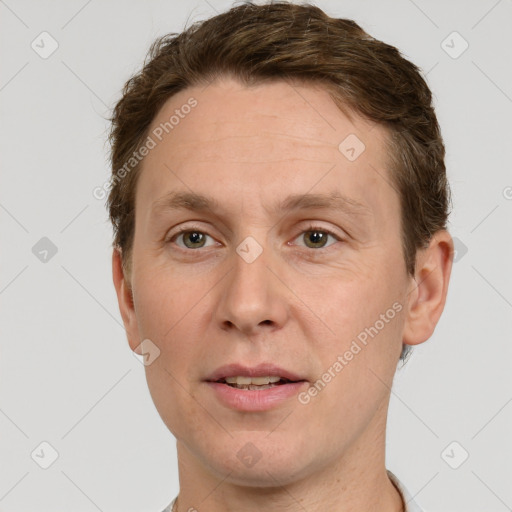 Joyful white adult male with short  brown hair and grey eyes