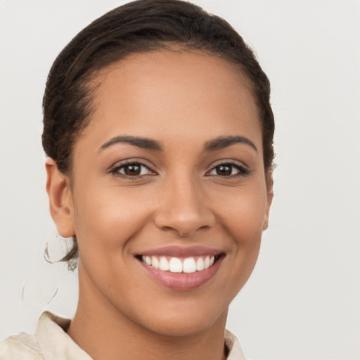 Joyful latino young-adult female with short  brown hair and brown eyes