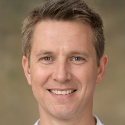 Joyful white adult male with short  brown hair and brown eyes