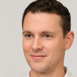 Joyful white adult male with short  brown hair and brown eyes