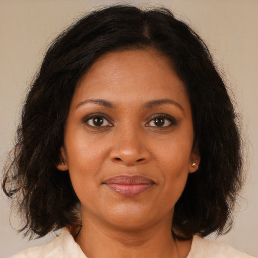 Joyful black young-adult female with medium  brown hair and brown eyes