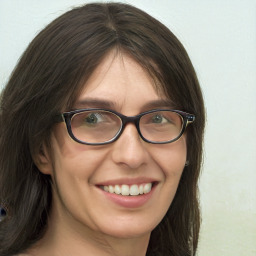 Joyful white young-adult female with long  brown hair and green eyes