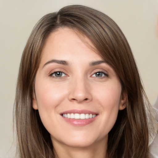 Joyful white young-adult female with long  brown hair and brown eyes