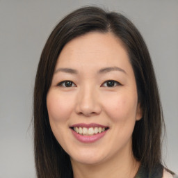 Joyful asian young-adult female with long  brown hair and brown eyes