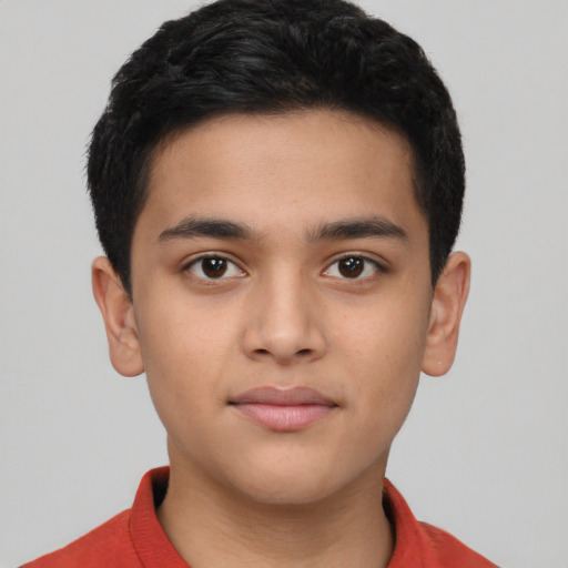 Joyful latino child male with short  brown hair and brown eyes