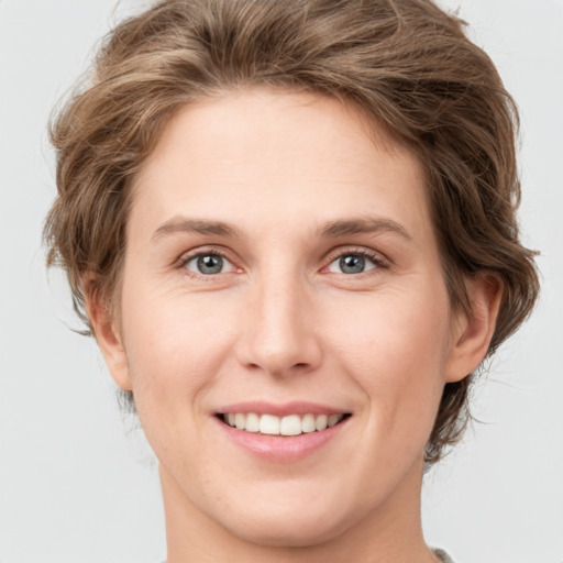 Joyful white young-adult female with medium  brown hair and green eyes