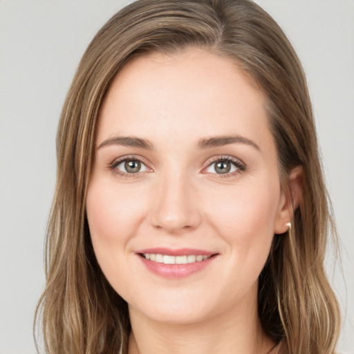 Joyful white young-adult female with long  brown hair and green eyes