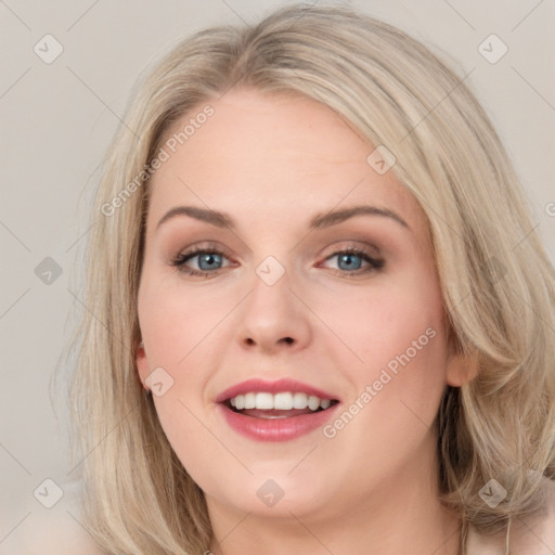 Joyful white young-adult female with long  brown hair and blue eyes