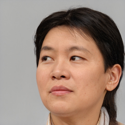 Joyful asian adult female with medium  brown hair and brown eyes