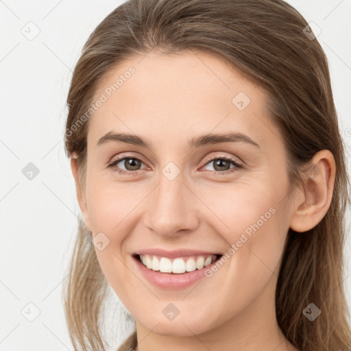 Joyful white young-adult female with long  brown hair and grey eyes