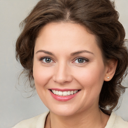 Joyful white young-adult female with medium  brown hair and brown eyes