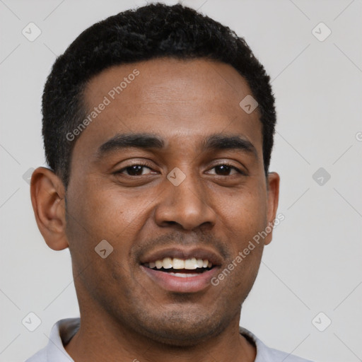 Joyful black young-adult male with short  black hair and brown eyes