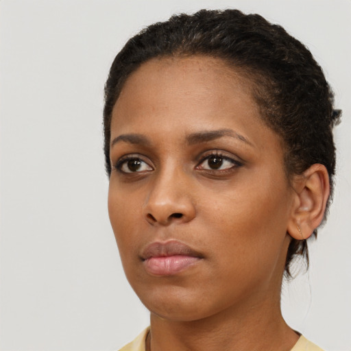 Neutral black young-adult female with short  brown hair and brown eyes