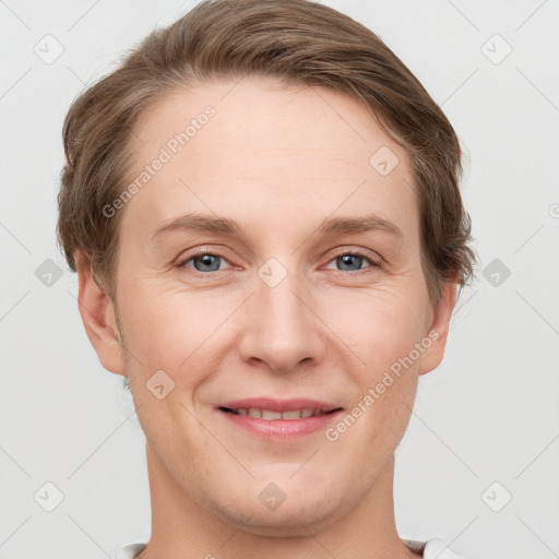 Joyful white young-adult female with short  brown hair and grey eyes