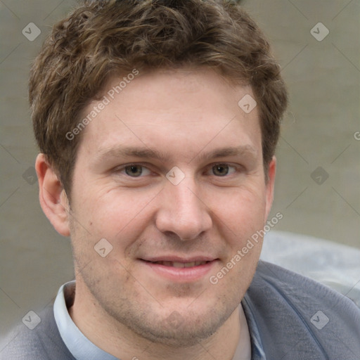 Joyful white adult male with short  brown hair and grey eyes