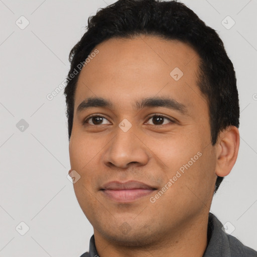 Joyful latino young-adult male with short  black hair and brown eyes