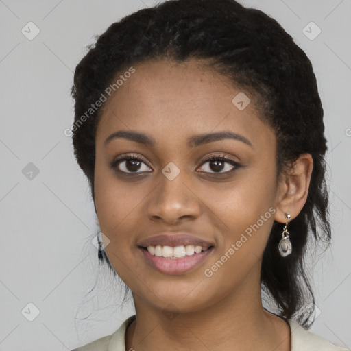 Joyful black young-adult female with long  black hair and brown eyes