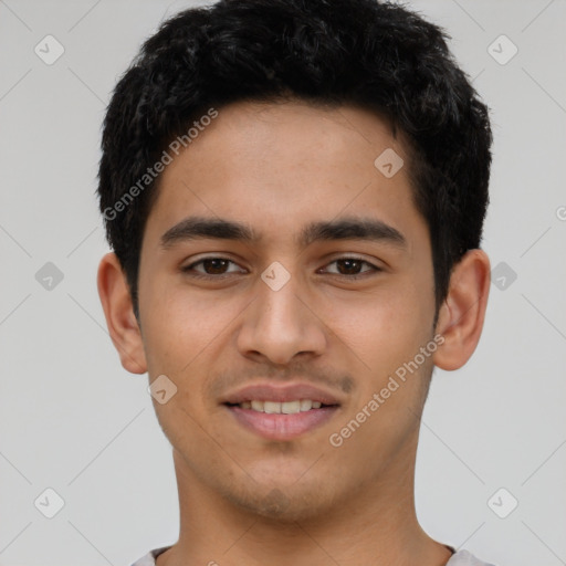 Joyful latino young-adult male with short  black hair and brown eyes