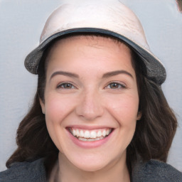 Joyful white young-adult female with medium  brown hair and blue eyes