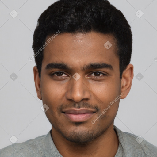 Joyful black young-adult male with short  black hair and brown eyes