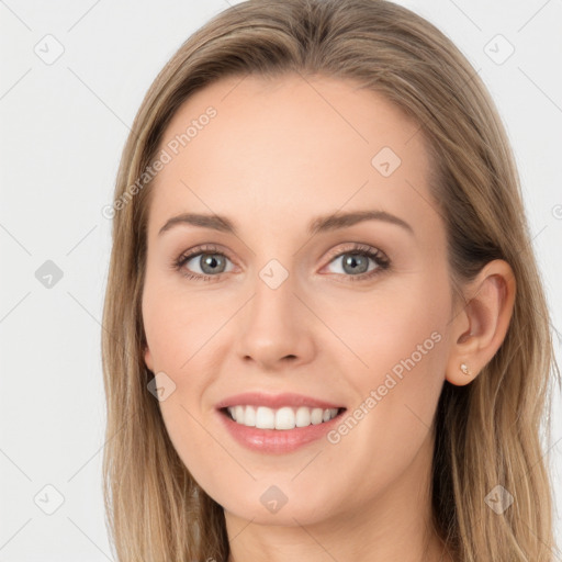 Joyful white young-adult female with long  brown hair and blue eyes