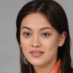 Joyful asian young-adult female with long  brown hair and brown eyes