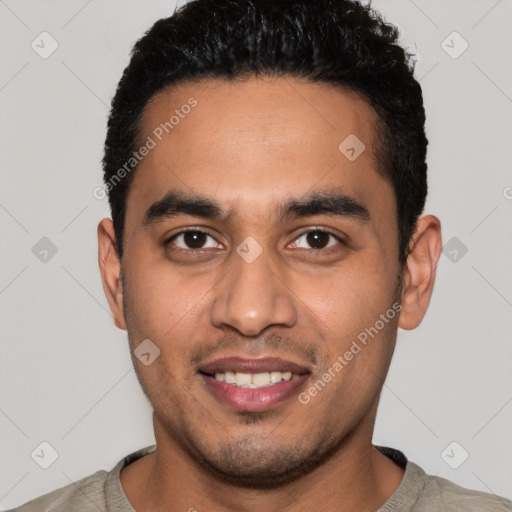 Joyful latino young-adult male with short  black hair and brown eyes