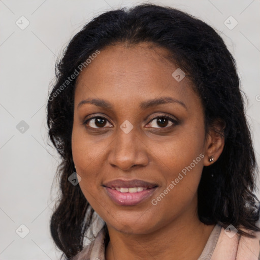 Joyful black young-adult female with long  brown hair and brown eyes