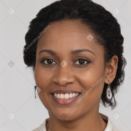 Joyful black young-adult female with short  black hair and brown eyes