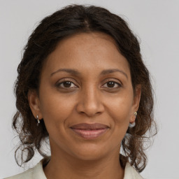 Joyful black adult female with medium  brown hair and brown eyes