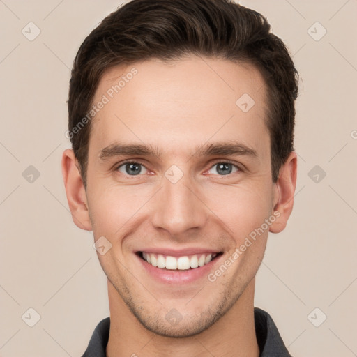 Joyful white young-adult male with short  brown hair and grey eyes