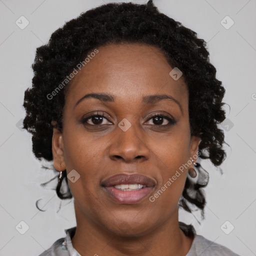 Joyful black adult female with short  brown hair and brown eyes