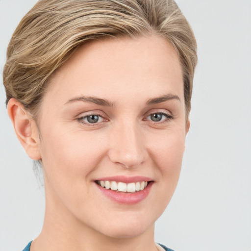 Joyful white young-adult female with medium  brown hair and blue eyes