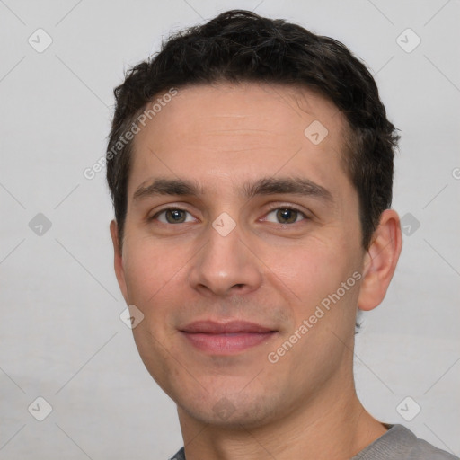 Joyful white young-adult male with short  black hair and brown eyes