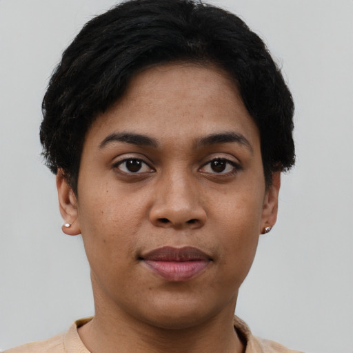 Joyful latino young-adult female with short  black hair and brown eyes