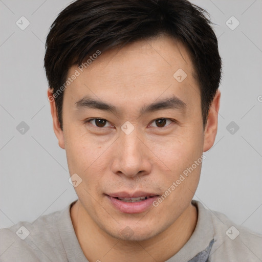 Joyful asian young-adult male with short  brown hair and brown eyes