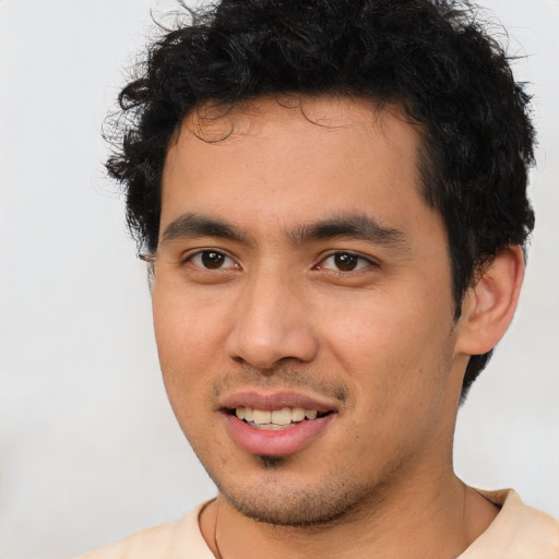 Joyful latino young-adult male with short  brown hair and brown eyes