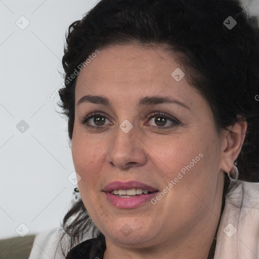 Joyful white adult female with long  brown hair and brown eyes